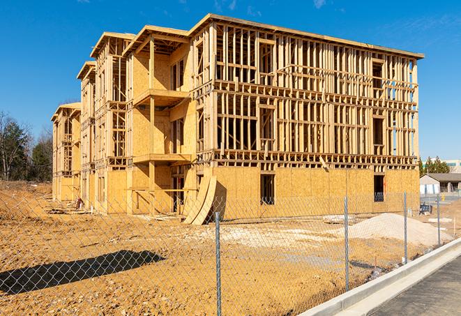 workers protected by temporary barrier fence during building maintenance in Alpine UT